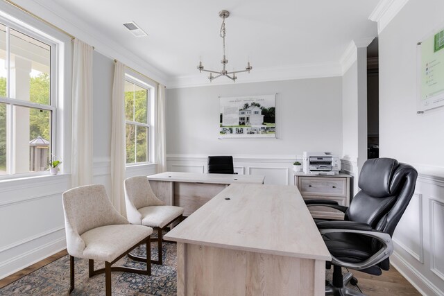 office space with visible vents, wainscoting, dark wood-style flooring, crown molding, and a decorative wall