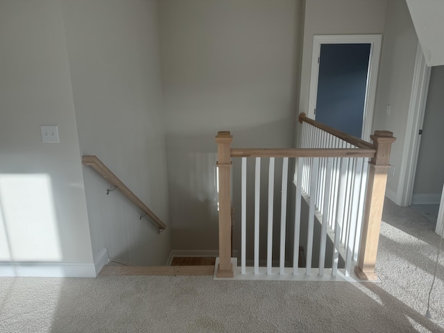 stairs featuring carpet floors and baseboards