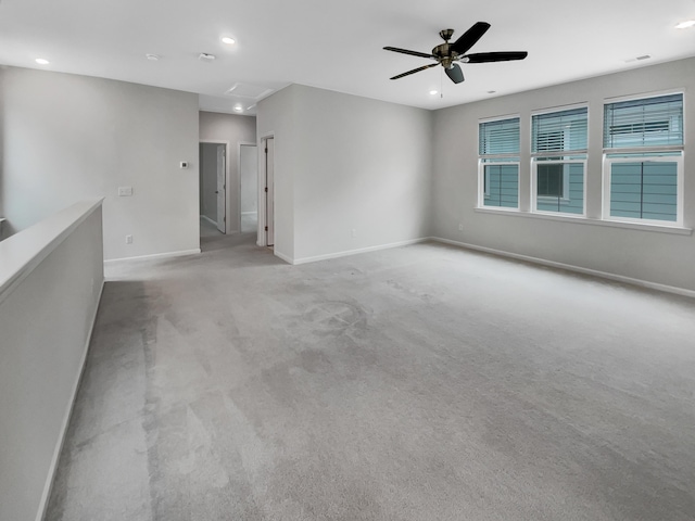 carpeted empty room featuring ceiling fan