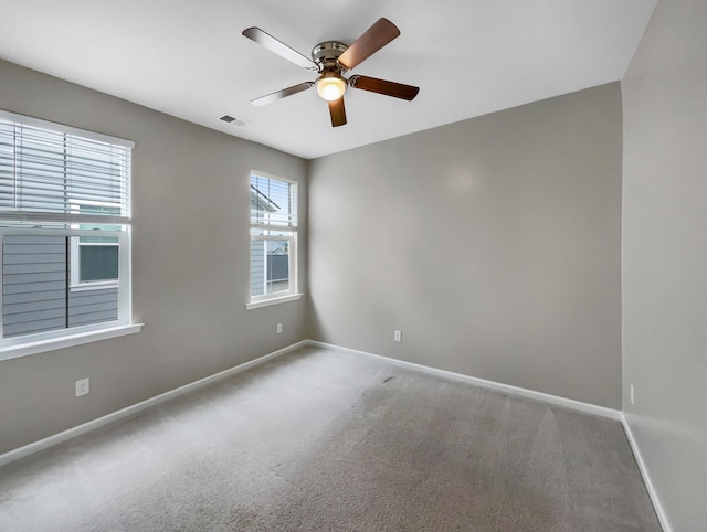 empty room with ceiling fan and carpet floors