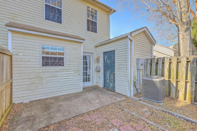 rear view of property with a patio and cooling unit