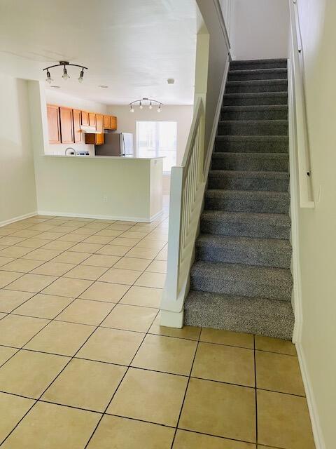145 Taylor Cir, Goose Creek, SC 29445 - stairs featuring track lighting, tile patterned floors, and baseboards