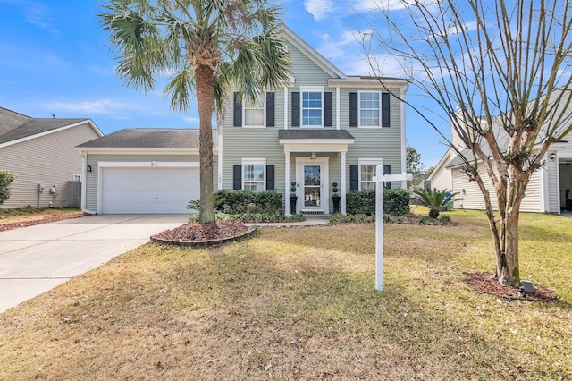 view of front of house featuring a garage, concrete driveway, and a front yard