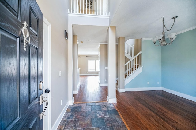 entryway with dark wood finished floors, baseboards, and stairs