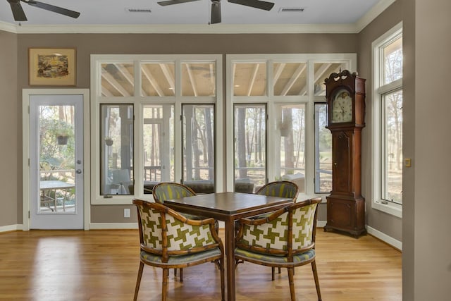 dining room featuring ornamental molding, a wealth of natural light, and visible vents