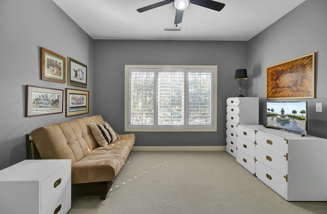 living area with light carpet, ceiling fan, visible vents, and baseboards