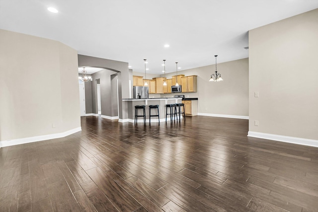 living room featuring dark hardwood / wood-style floors and an inviting chandelier