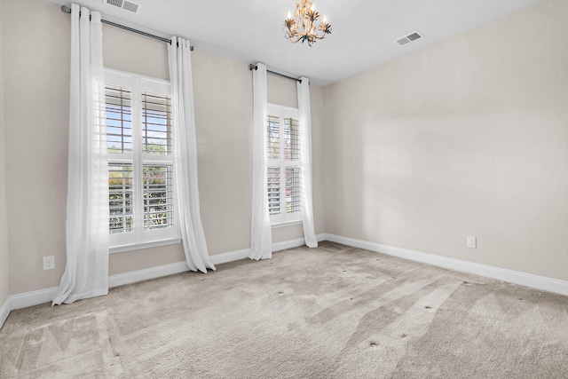 unfurnished bedroom with light carpet and a chandelier