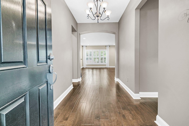 foyer featuring dark hardwood / wood-style flooring and a chandelier