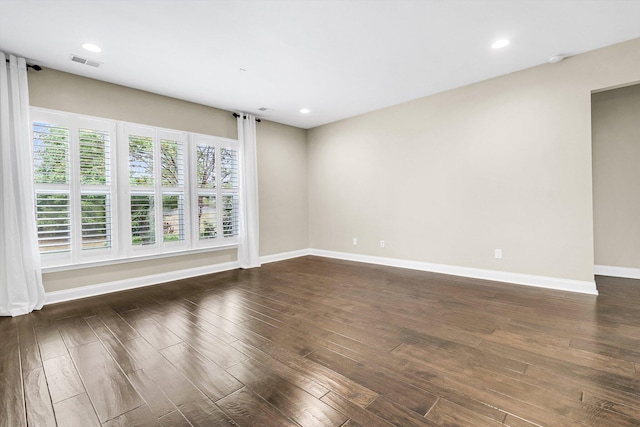 empty room with dark wood-type flooring