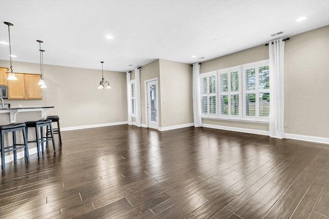 living room with an inviting chandelier and dark hardwood / wood-style floors