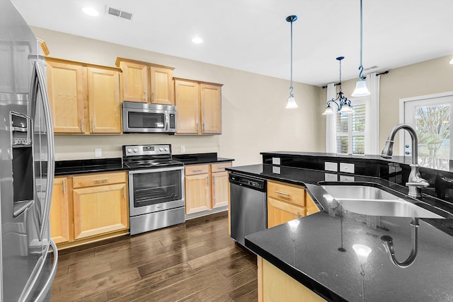 kitchen featuring light brown cabinets, sink, decorative light fixtures, stainless steel appliances, and dark hardwood / wood-style floors