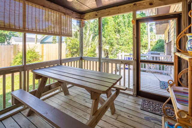 sunroom featuring ceiling fan