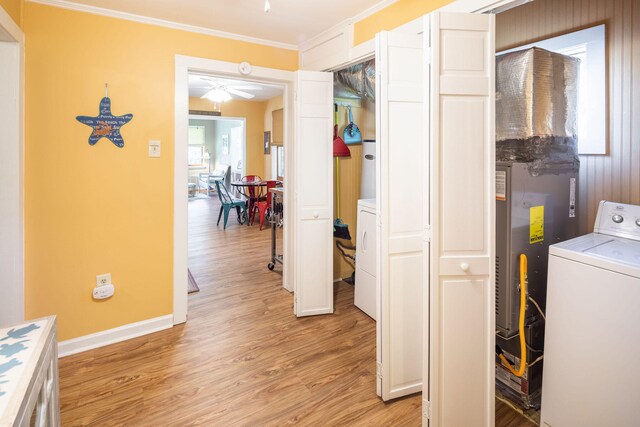 washroom with crown molding, ceiling fan, light hardwood / wood-style floors, and washer / dryer