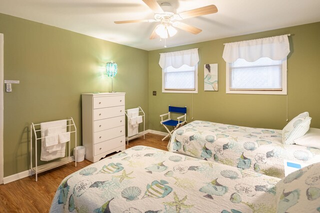 bedroom featuring hardwood / wood-style flooring and ceiling fan