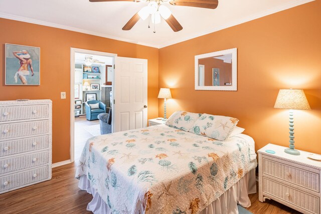 bedroom featuring ceiling fan, ornamental molding, and hardwood / wood-style flooring