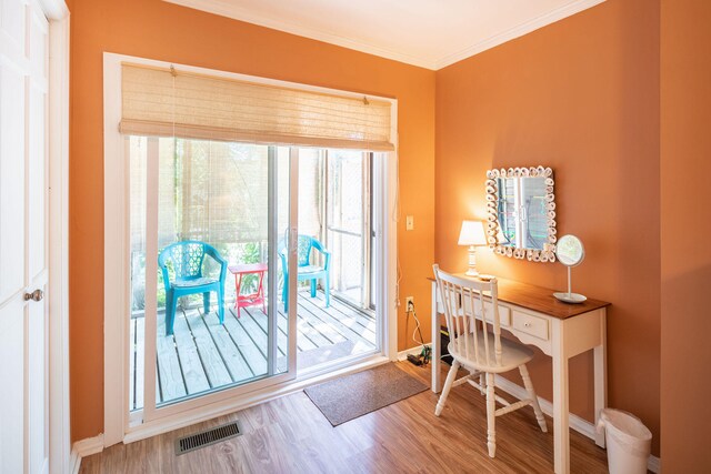 office with crown molding, plenty of natural light, and hardwood / wood-style floors