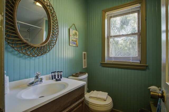 bathroom with plenty of natural light, toilet, walk in shower, and vanity