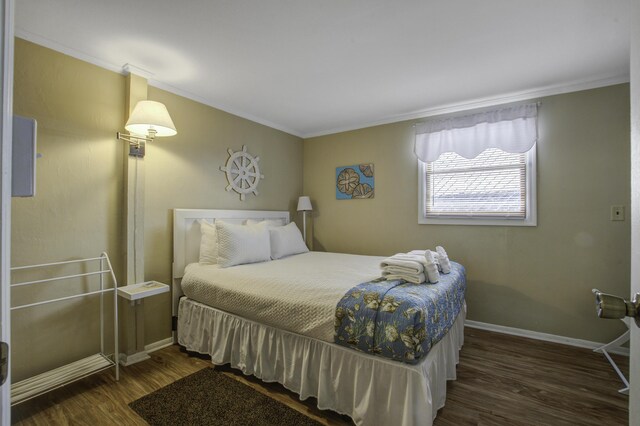 bedroom featuring dark hardwood / wood-style floors and crown molding