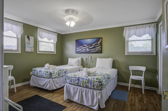 bedroom with multiple windows, ceiling fan, and hardwood / wood-style floors