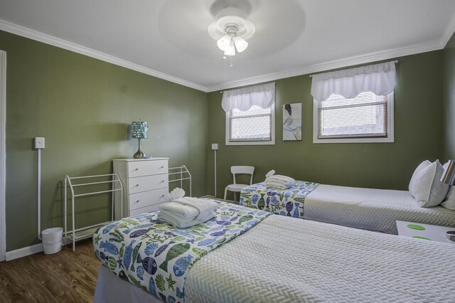 bedroom with ceiling fan, crown molding, and dark hardwood / wood-style floors