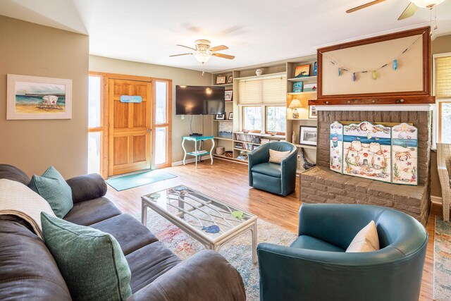 living room with ceiling fan and light hardwood / wood-style floors