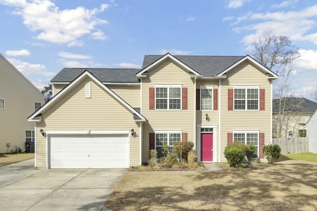 view of front of property with a garage, concrete driveway, and fence