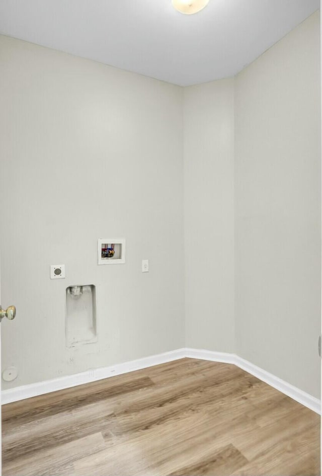 washroom featuring washer hookup, electric dryer hookup, wood finished floors, laundry area, and baseboards