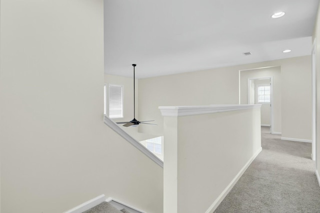 hallway featuring recessed lighting, light carpet, visible vents, an upstairs landing, and baseboards