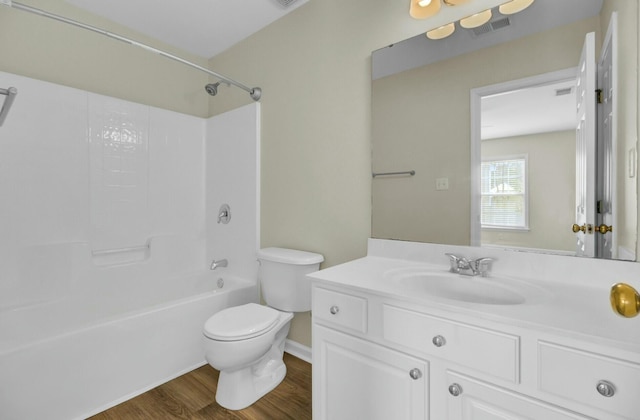 full bathroom with visible vents, toilet, wood finished floors, tub / shower combination, and vanity