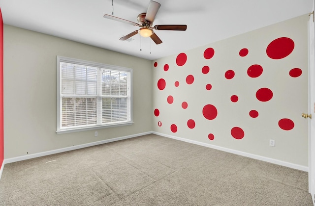 spare room featuring a ceiling fan, baseboards, and carpet flooring