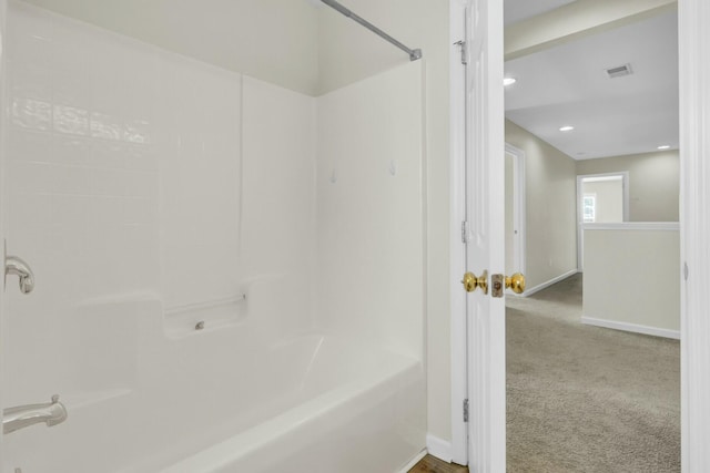 bathroom featuring  shower combination, visible vents, and baseboards