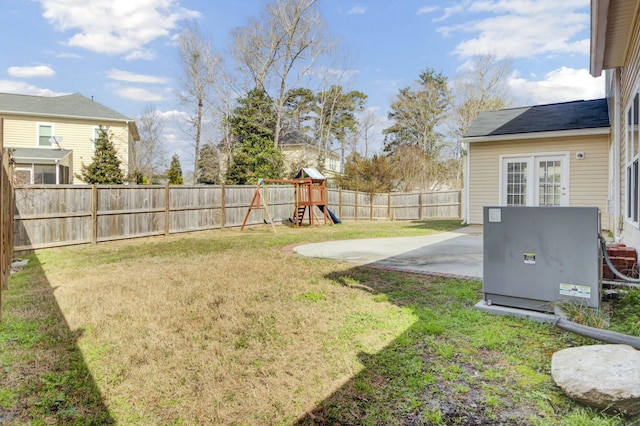 view of yard featuring a playground, a patio, and a fenced backyard