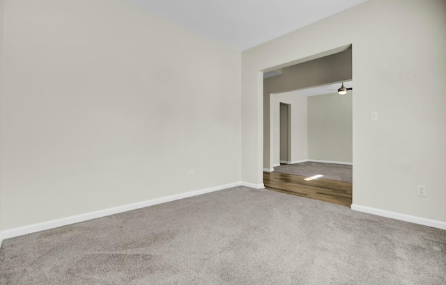 empty room featuring baseboards and carpet flooring