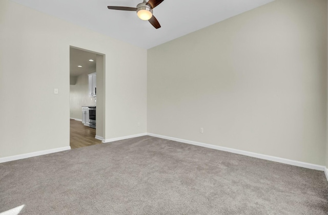 unfurnished room with a ceiling fan, carpet, baseboards, and recessed lighting