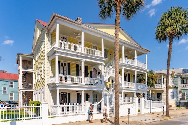 coastal home featuring a balcony and ceiling fan