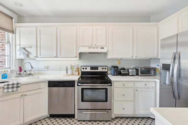 kitchen with white cabinetry, stainless steel appliances, and sink