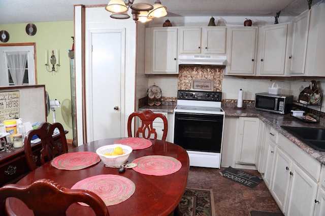 814 Armsway St, Mount Pleasant, SC 29464 - kitchen with white electric stove, under cabinet range hood, stainless steel microwave, tasteful backsplash, and white cabinets