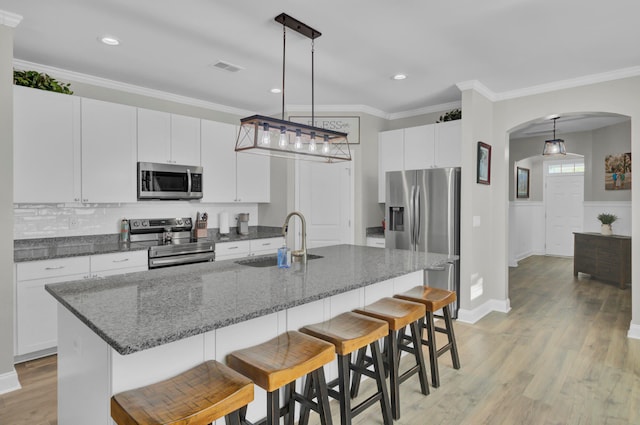 kitchen featuring sink, appliances with stainless steel finishes, and white cabinetry