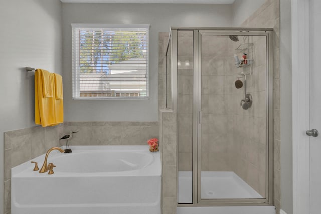 bathroom featuring separate shower and tub