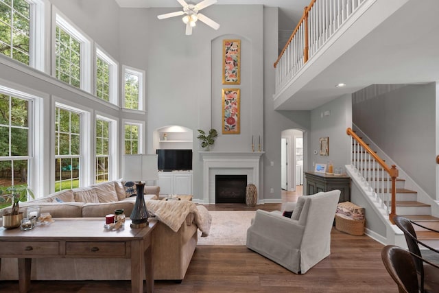 3574 Toomer Kiln Cir, Mount Pleasant, SC 29466 - living area featuring a high ceiling, ceiling fan, arched walkways, wood finished floors, and stairs