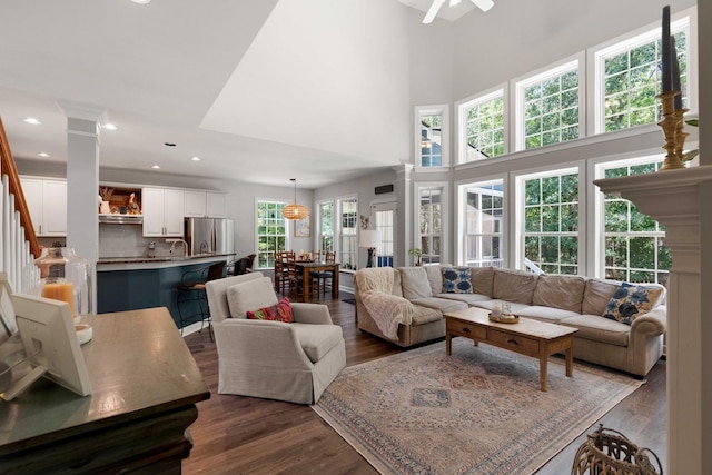 3574 Toomer Kiln Cir, Mount Pleasant, SC 29466 - living room featuring ornate columns, dark wood-style flooring, ceiling fan, a towering ceiling, and recessed lighting