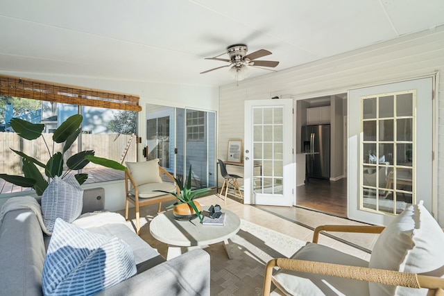 sunroom / solarium with ceiling fan and french doors