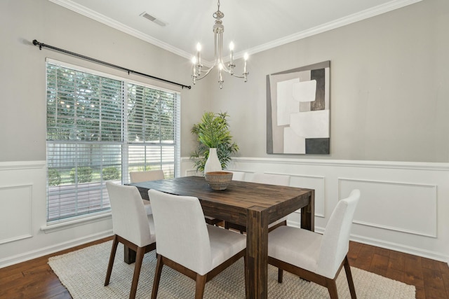 dining space featuring a wainscoted wall, dark wood-type flooring, visible vents, and crown molding