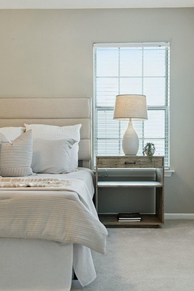 carpeted bedroom with baseboards