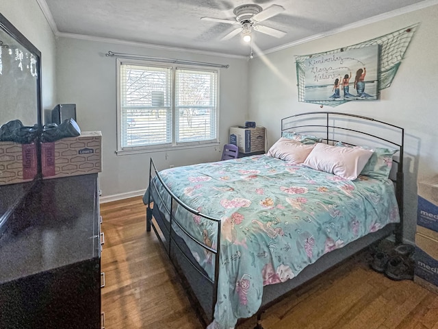 bedroom with crown molding, dark wood-type flooring, and ceiling fan