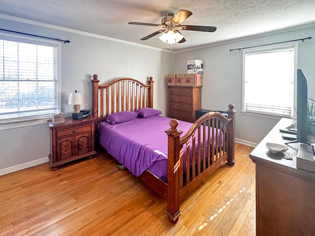 bedroom with crown molding, ceiling fan, light hardwood / wood-style floors, and multiple windows