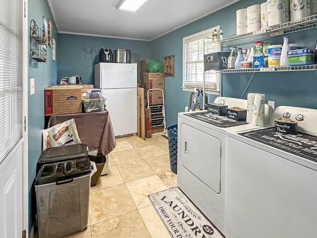 laundry area featuring light tile patterned flooring, ornamental molding, and independent washer and dryer