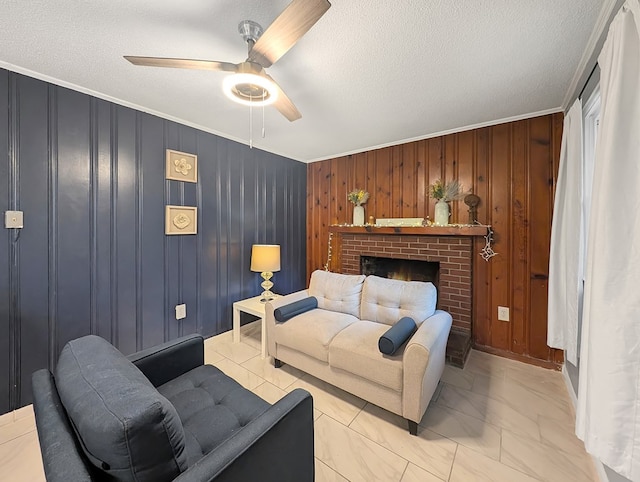 living room with a fireplace, a textured ceiling, ornamental molding, and wood walls