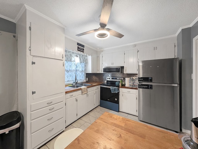 kitchen featuring sink, stainless steel appliances, tasteful backsplash, white cabinets, and ornamental molding